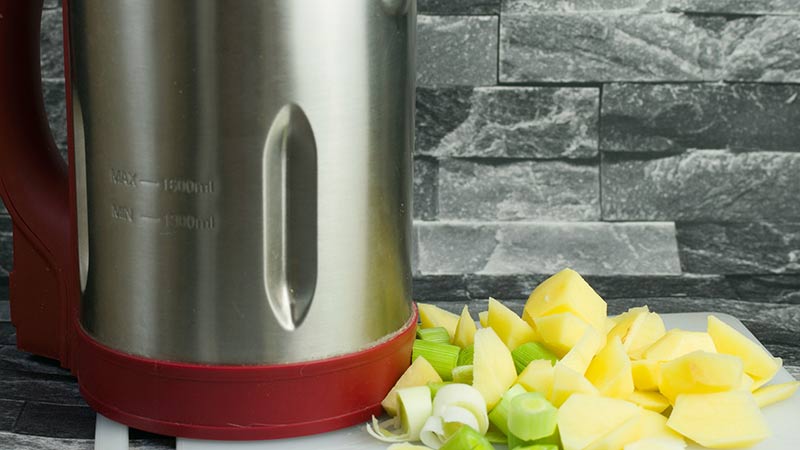 soepmaker met gesneden verse groente ernaast